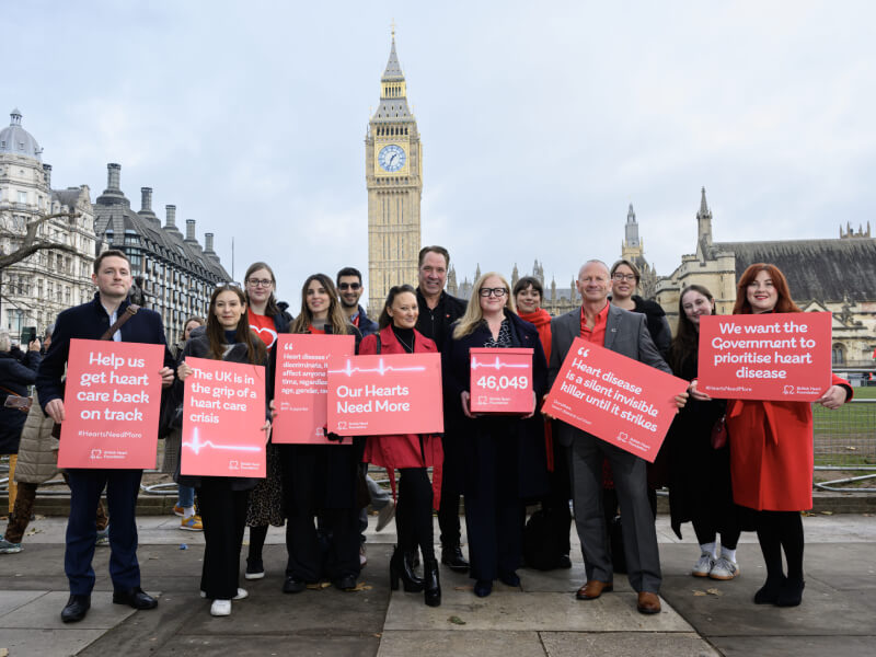Campaigners outside the Big Ben in London holding up BHF posters