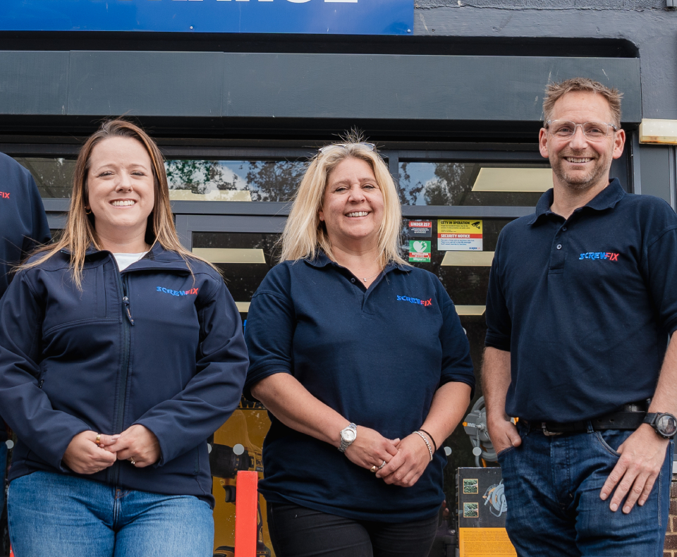 Screwfix employees, standing outside a store.