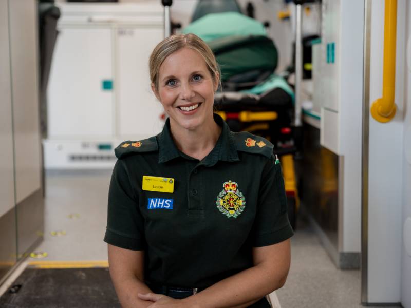 Photograph of a paramedic in uniform smiling