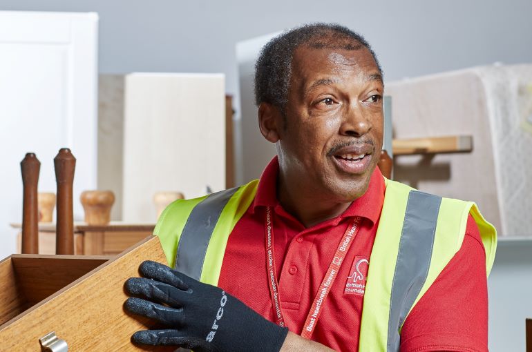 Michael lifting a piece of furniture
