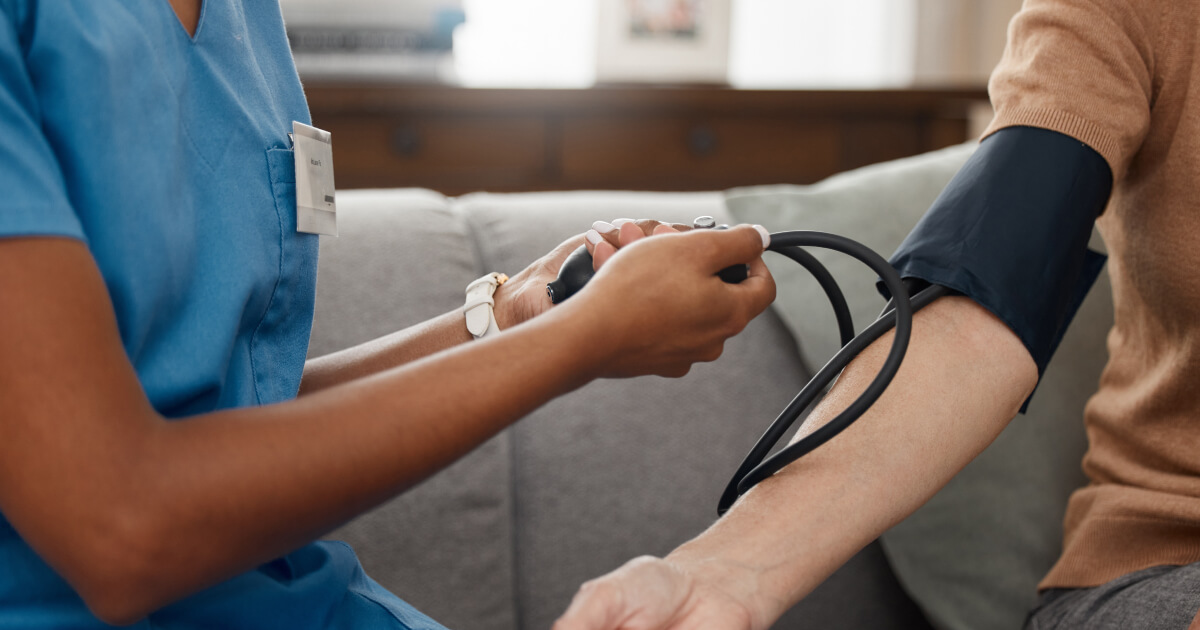 Nurse taking patient's blood pressure