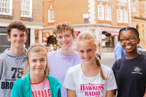 Group of five teenagers on a high street