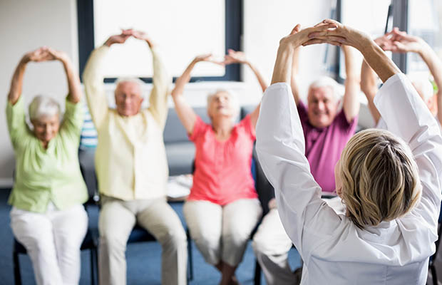 5 seniors are shown how to do chair exercises