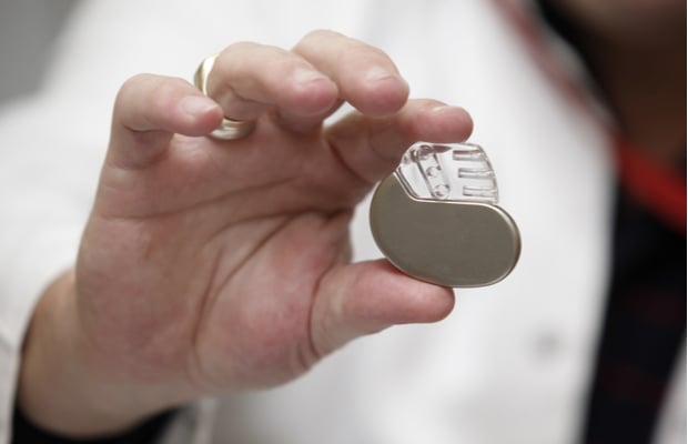 Man holding a pacemaker between his fingers