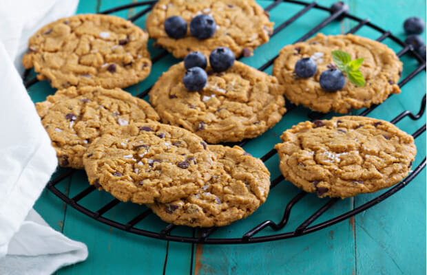 A plate of gluten free biscuits topped with blueberries