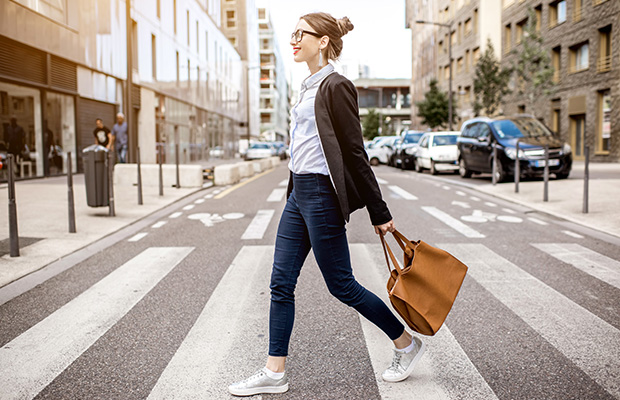 A woman crossing a road at a zebra crossing