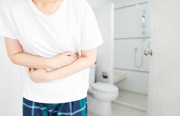 Man with a bad stomach by a toilet