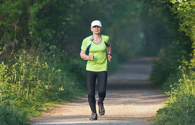 Senior woman running outside