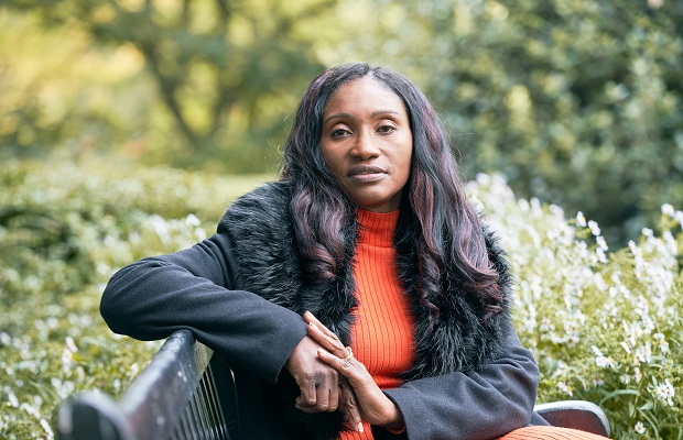Heart event survivor Carol Ighofose sitting in York Gardens