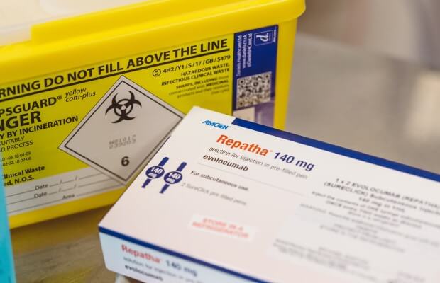 PCSK9 inhibitors in a packet alongside a sharps bin