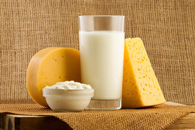 Milk, cheese and yoghurt on a wooden worktop