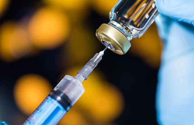 Needle in a vial of vaccine