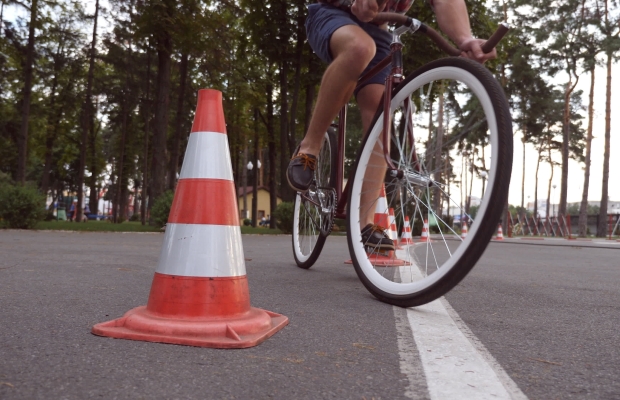 cyclist navigating a traffic cone