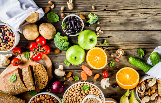A selection of fresh vegetables, fruits, legumes, and nuts.