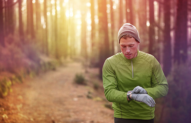 Man running and looking at his smart watch