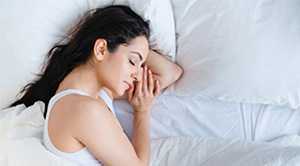 A woman sleeping in bed.