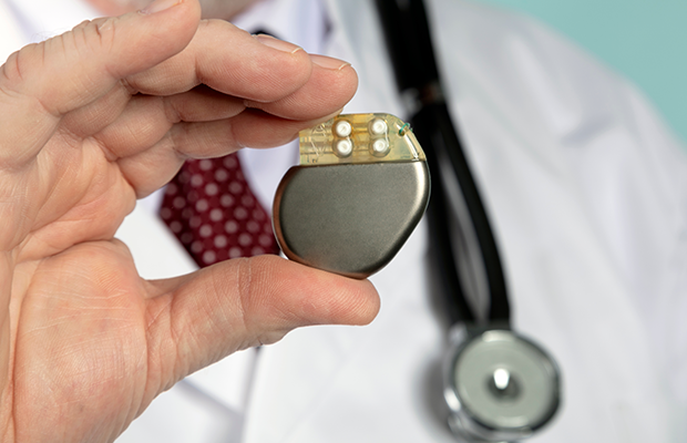 Doctor holding a pacemaker