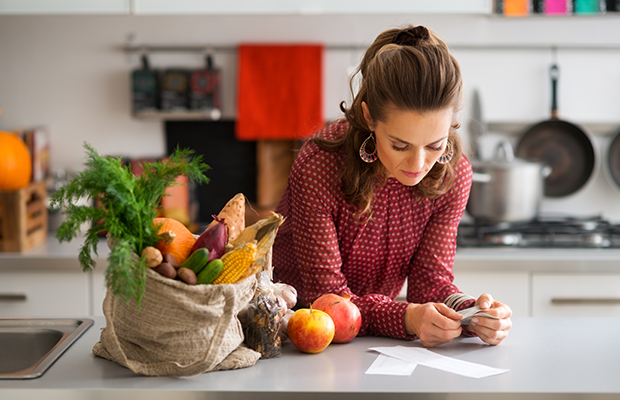 Woman in kitchen with food shopping