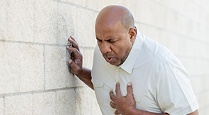 Man clutching his chest.