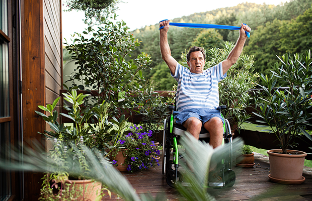 Man doing stretching exercise in wheelchair