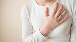 Woman with hand on chest