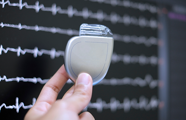 Hand holding an implantable cardioverter defibrillator (ICD)