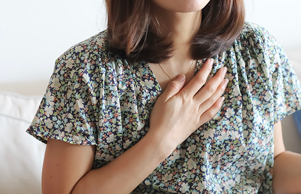 Woman with hand on chest