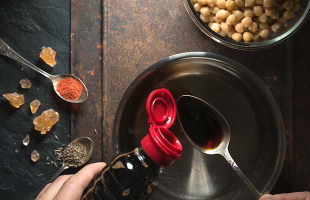 Pouring soy sauce into a spoon