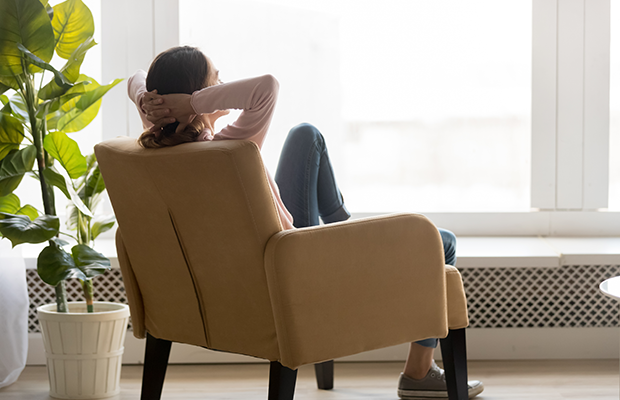 Woman sitting in chair by a window