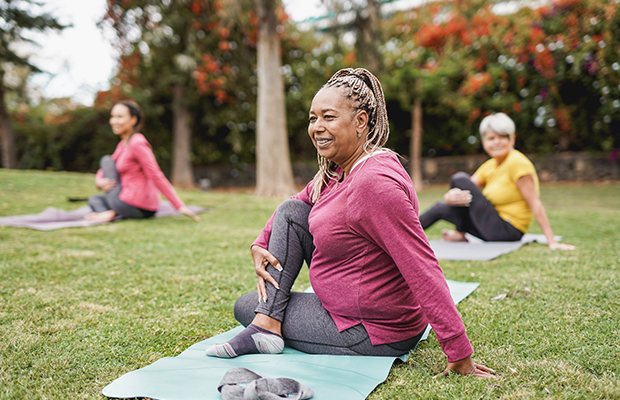 Senior group taking part in yoga in a park