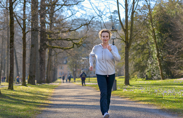 Woman walking briskly in park