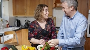 Couple cooking with vegetables
