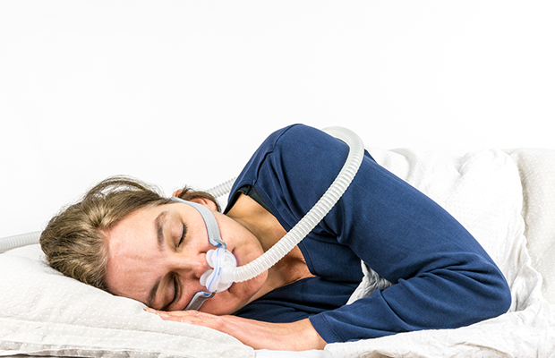 Woman sleeping with CPAP machine