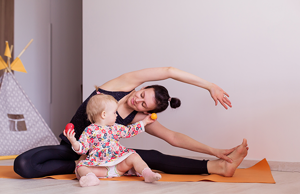 Parent doing yoga at home with child
