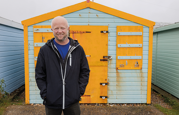 Gary Rolfe outside a beach hut