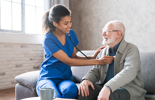 Nurse with stethoscope and patient