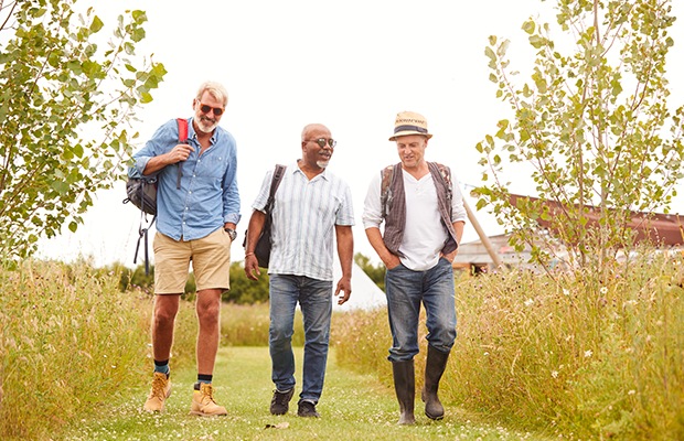 Older men walking together through a field
