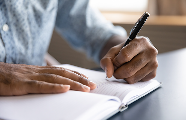 A pair of hands writing