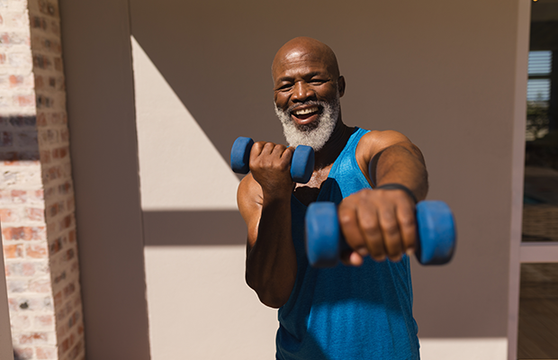 Elderly man using dumbbells