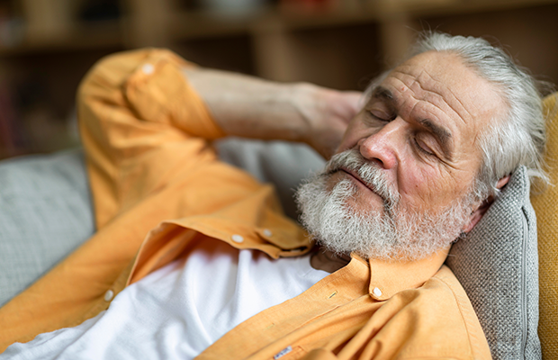 Elderly man having a nap during the day