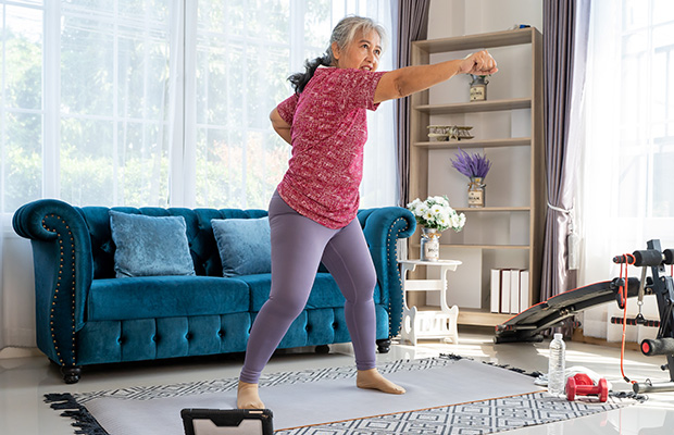 A person punching the air in the living room at home