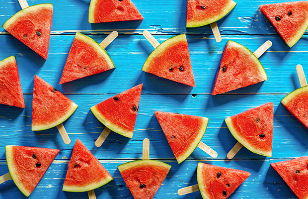 Watermelon popsicle slices on a blue background