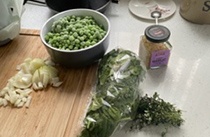 Ingredients for a pea soup recipe laid out on a kitchen counter