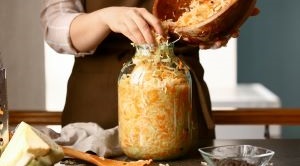 A person making pickled cabbage.