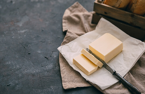 Block of butter with a knife through the middle