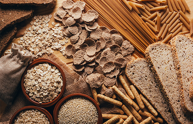 slices of brown bread, dried wholemeal penne and other high fibre foods on a table