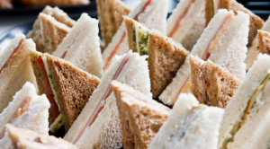 A platter of white and brown bread sandwiches