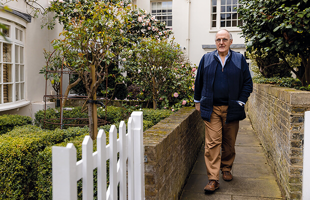 Laurence Humphreys-Davies walks down a walled garden path