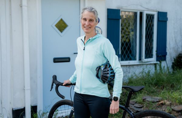 Beth Greenaway stands with her bike outside her house in Cornwall.