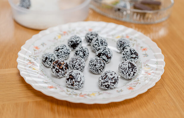 A plate of chokito – puffed rice balls with dates and cocoa powder, rolled in coconut.